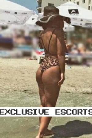 Surrey escort in leopard print swimsuit at the beach