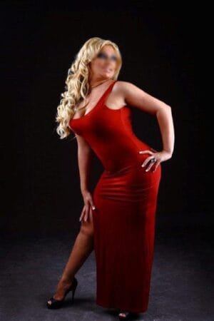 mature blonde Edinburgh escort in long red dress
