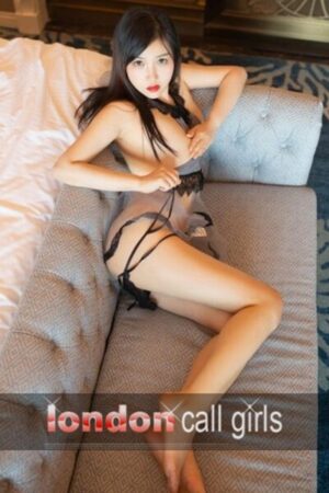 Chloe Sexy Singaporean London Escort laid on the sofa