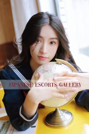 Dada Sexy Asian Escort in Mayfair next to a globe