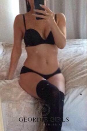 sexy Newcastle escort taking a selfie on the bed