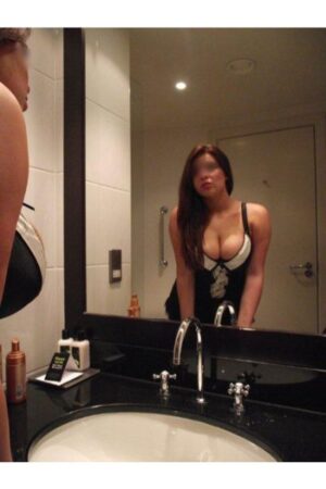 busty Glasgow escort posing in the mirror