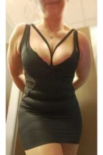 Busty Luton escort in tight black dress