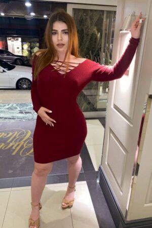 Medina Curvaceous London Escort poses in the foyer