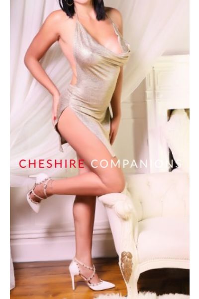 woman in silver negligee with knee on chair