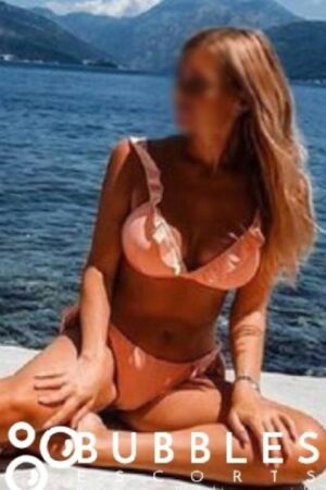 Madelyn Young European Escort in London in orange swimwear