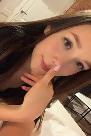 young pretty Asian Bristol Escort with pink nail polish