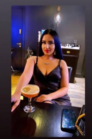 seductive OWO London Escort with a cocktail