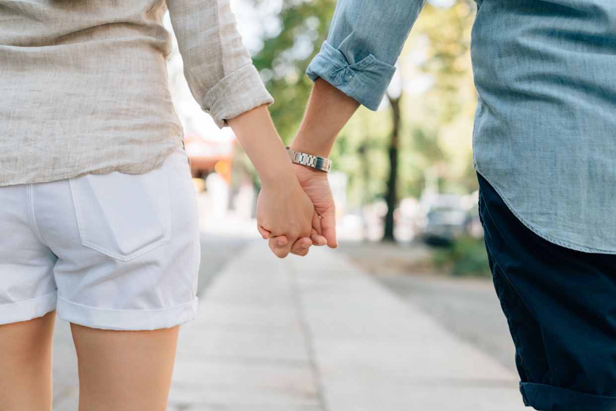 Man and woman holding hands