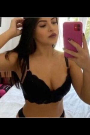 brunette Bradford Escort takes selfie with pink phone