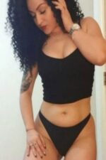 frizzy haired Carlisle escort in black pants