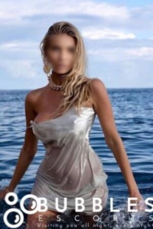 Esmer Blonde Park Lane Escort poses in the sea