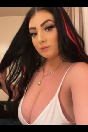 brunette and red haired Derby escort in a white bra