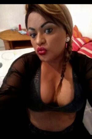 pouting TS Derby escort in small black bra