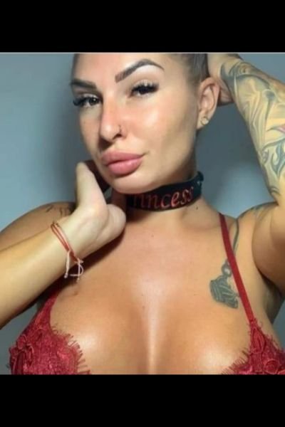 blonde tattooed escort in a red bra