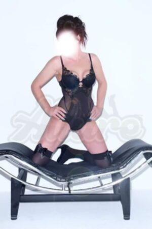 Newcastle escort in black lingerie kneeling on a curved seat