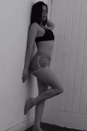 young Bolton escort with her foot up on wall