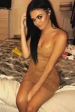 bronzed Middlesbrough escort in a beige dress