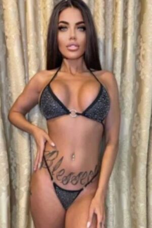 Outcall Sussex escort with stomach tattoo