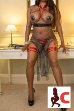 mocha skinned Monaghan escort in chain male outfit