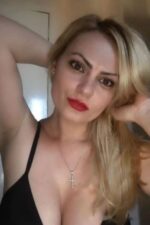 blonde exotic Renfrewshire escort with cross necklace