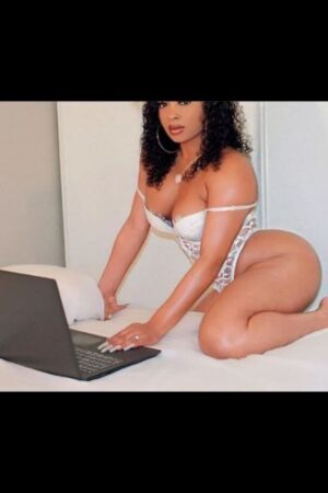 beautiful mocha Brighton escort in white teddy