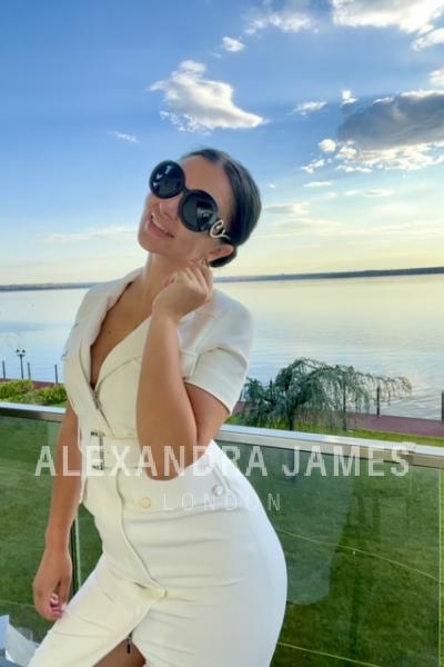 high class companion in white button down dress