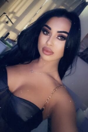 pouty lipped Roleplay London Escort in a cocktail dress