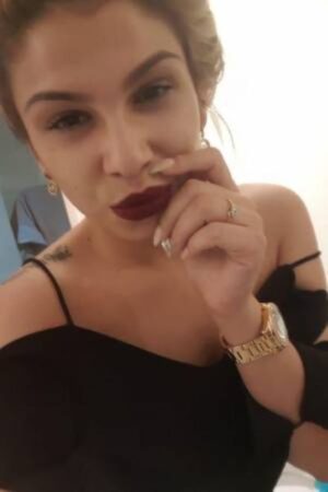 Cleo Domination London Escort wearing a gold watch