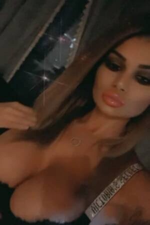 Monica Sexy Legs London Escort shows cleavage