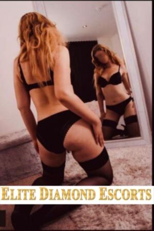 Nottingham escort in black knickers looking in her mirror