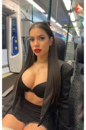 Brunette Dundee Escort with large breasts on a train