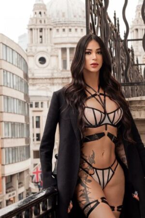 TS Mickaella in a blazer on a balcony