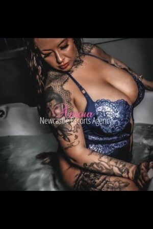 Busty Brunette Charley Glee displaying her tattoos and large tits