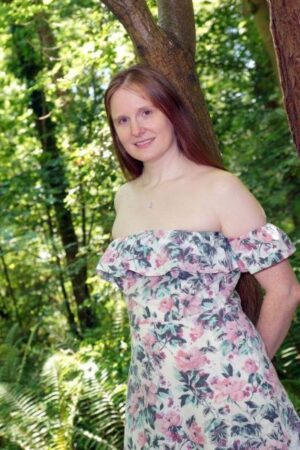 Auburn Delight in a floral dress outside