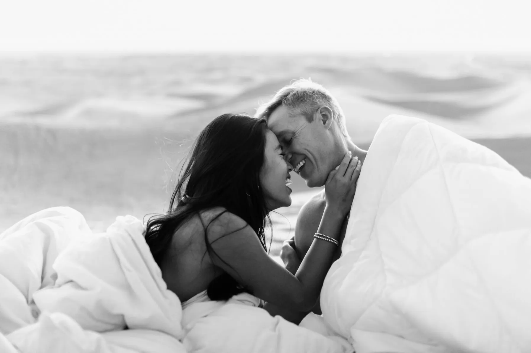 Male escort in bed with a woman