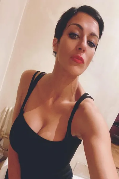 Sexy London Escort wearing a black vest