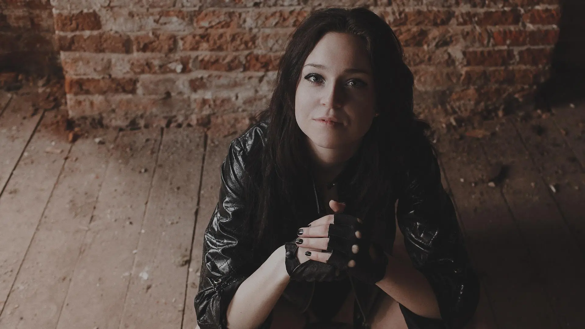 Young woman wearing leather gloves and jacket
