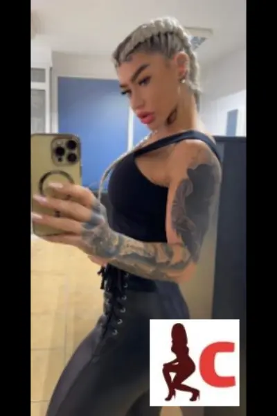 Tattooed blonde escort taking a selfie