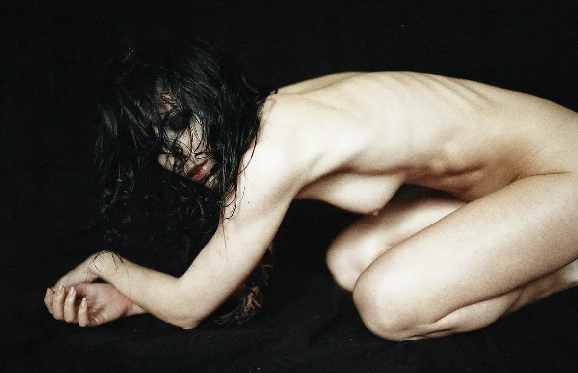 Naked woman doing yoga