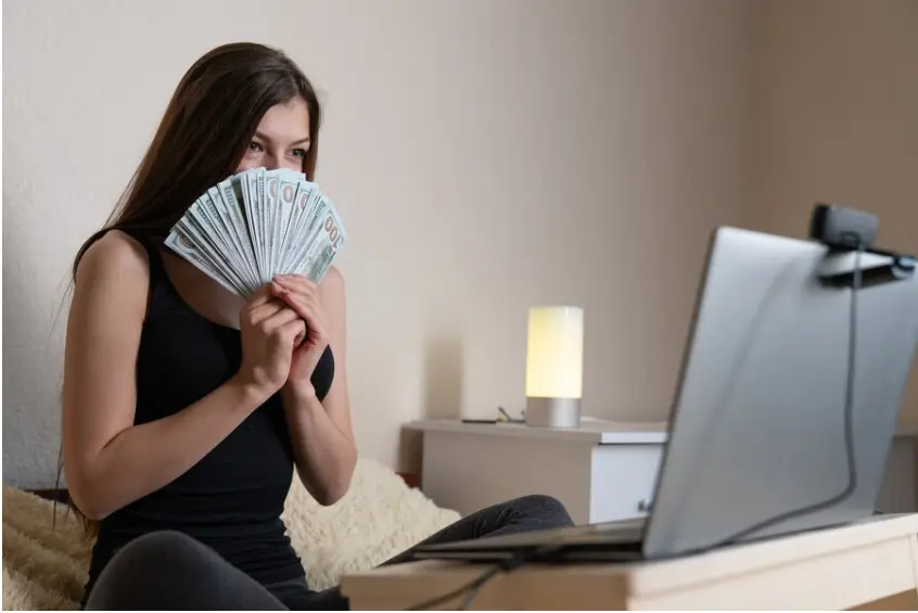 Brunette content creator holding lots of money