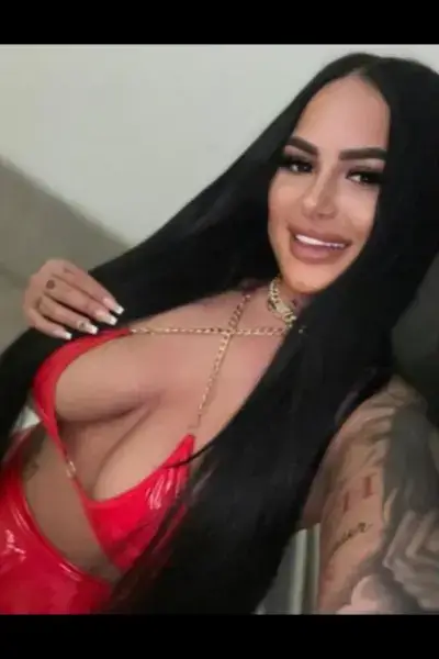 Smiling Manor park escort in a red PVC dress