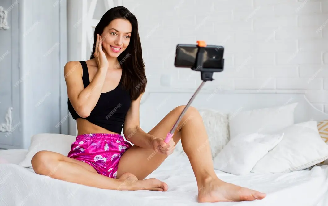 Woman filming herself in bed