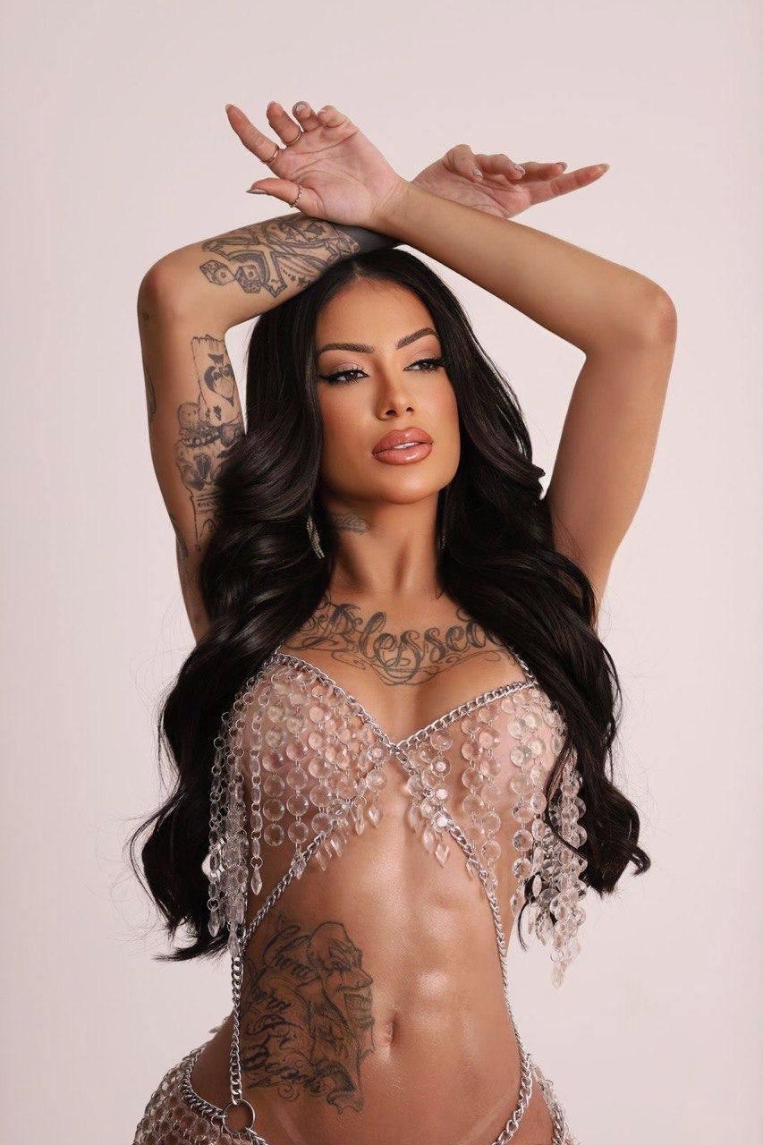 Sexy tattooed escort in glass bead outfit