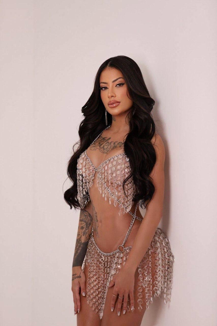 Sexy tattooed escort in glass bead outfit