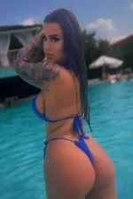 Tattooed escort in the pool