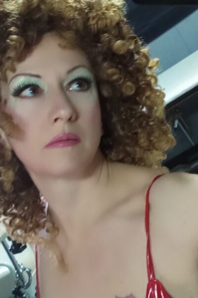 Curly haired escort taking a selfie