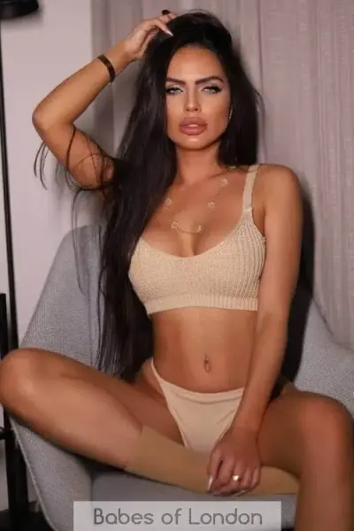 Beautiful brunette escort in beige lingerie