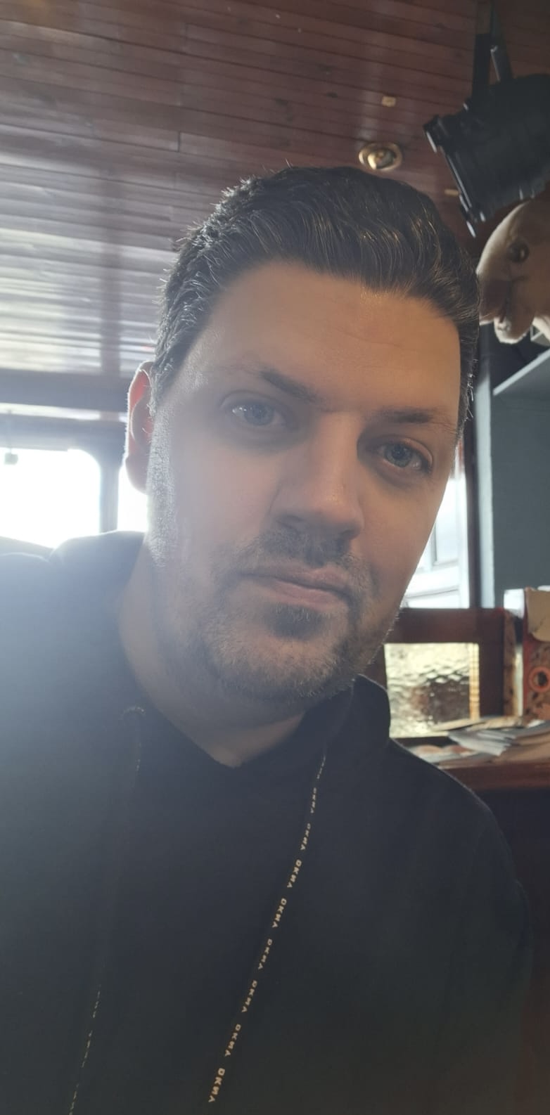 Male escort in black zip up