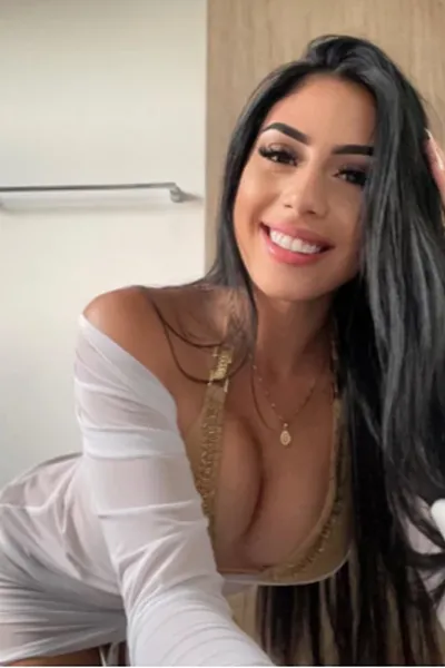 Busty brunette escort in a gold bikini